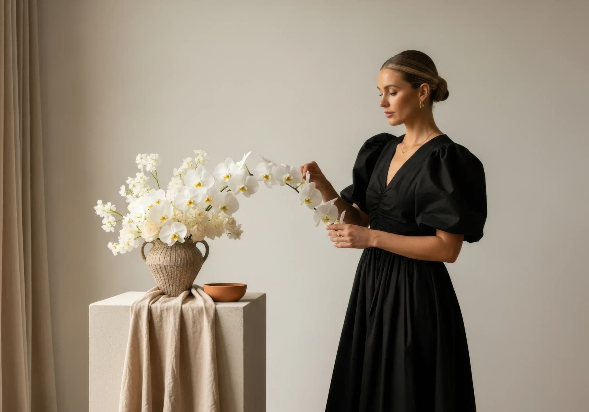 A styled brand content scene with flowers and a person arranging details