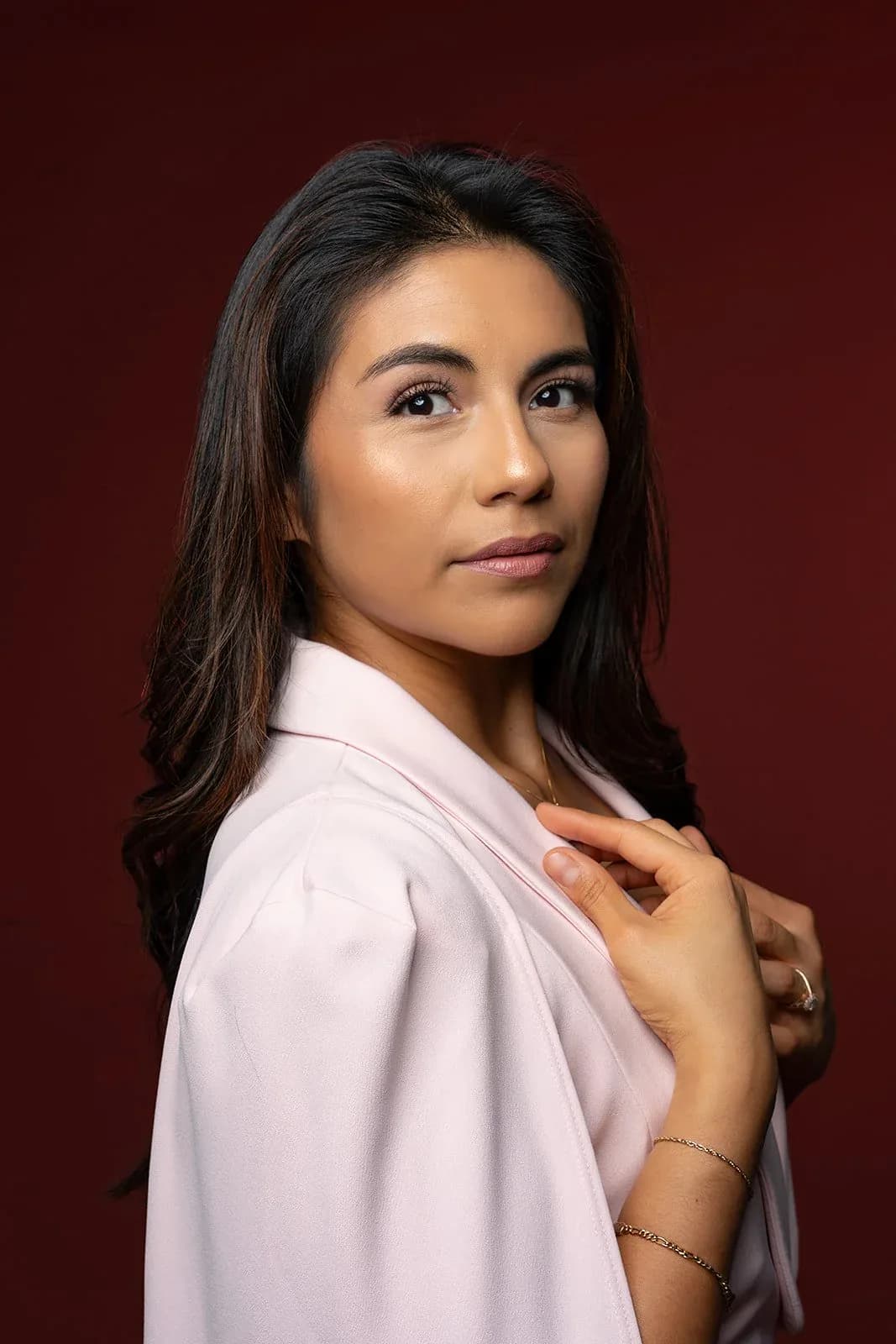 Editorial business portrait against a rich red studio backdrop