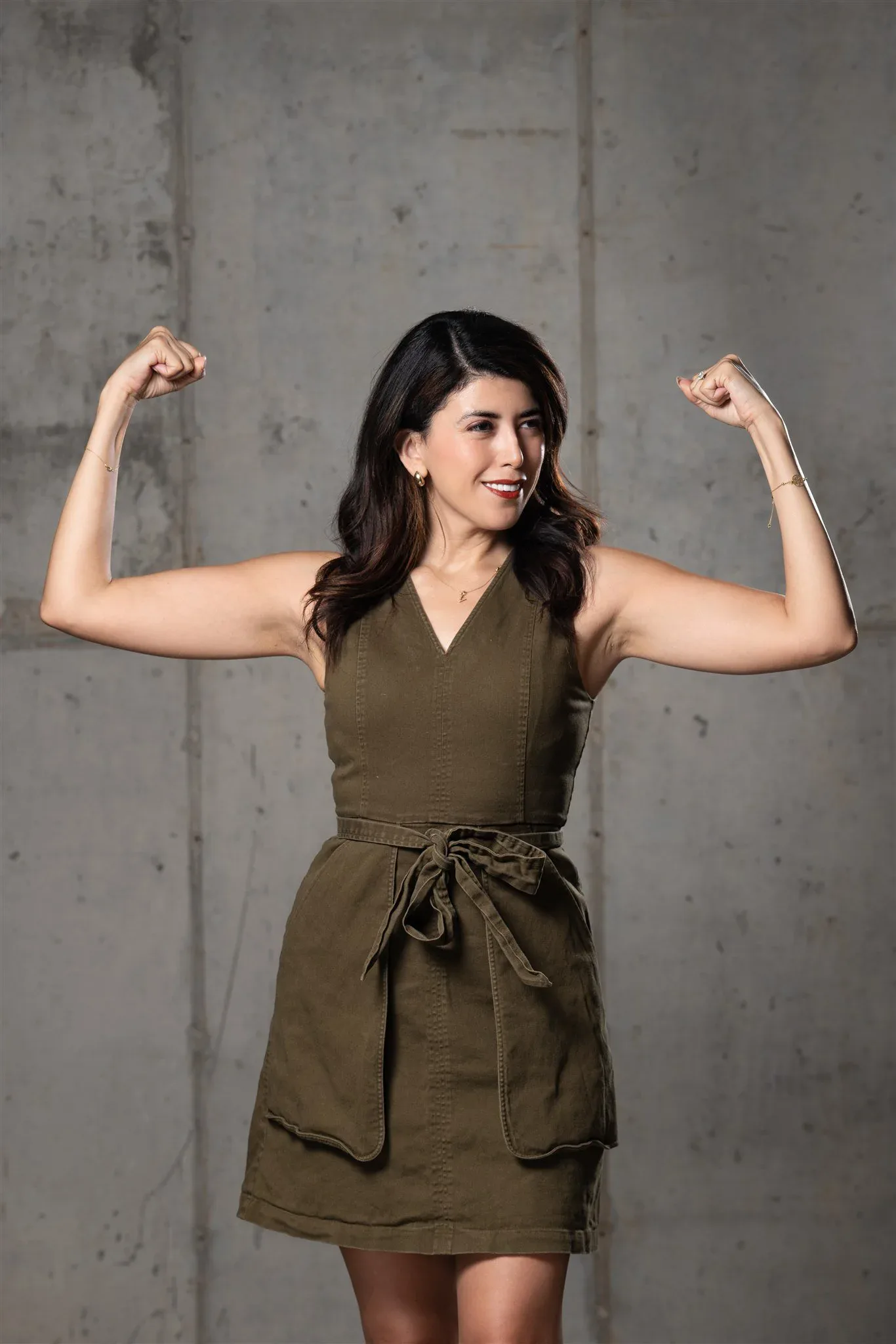 Confident personal brand portrait against a concrete studio wall